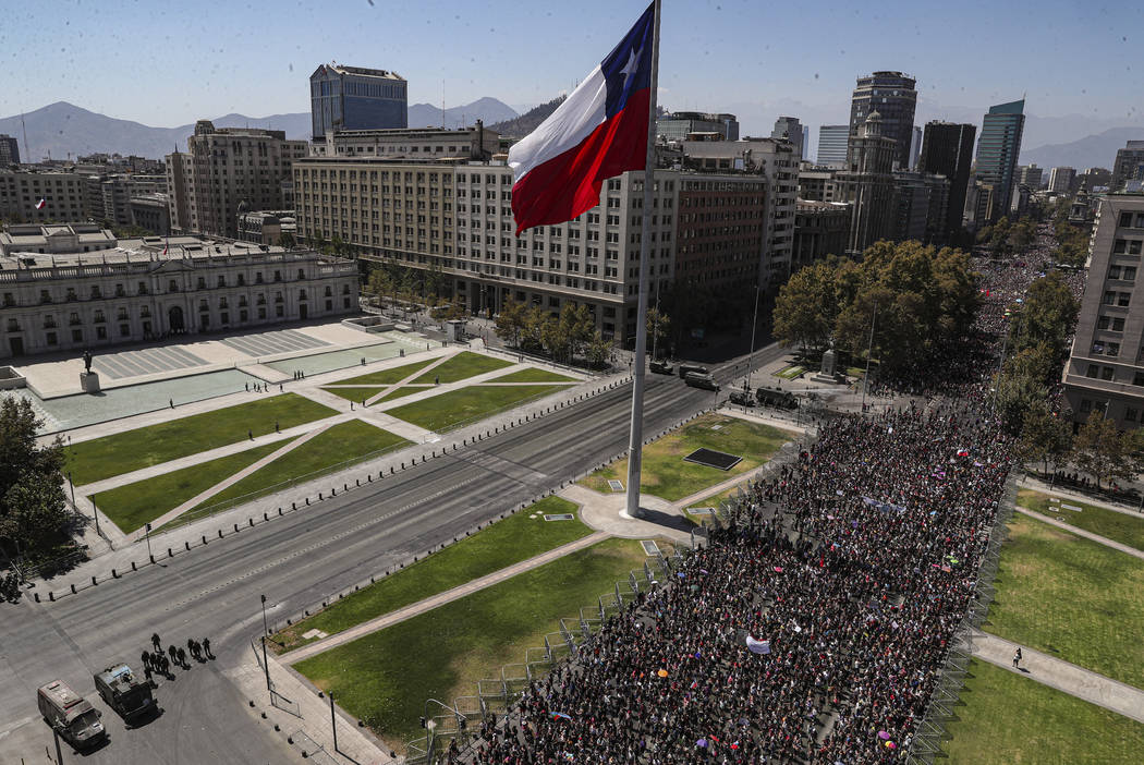 Women march near La Moneda presidential palace during a protest marking International Women's D ...