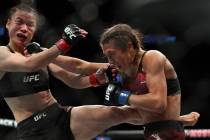 Weili Zhang, left, and Joanna Jedrzejczyk trade blows during the third round of their UFC 248 f ...