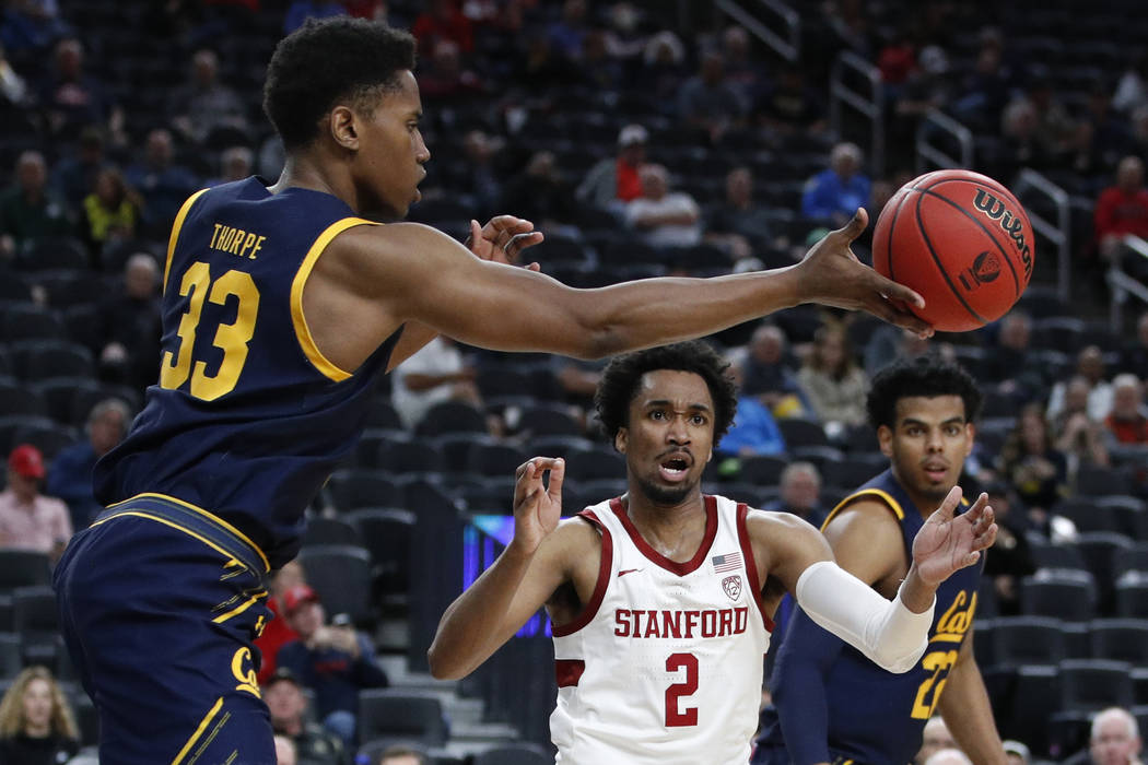 California's D.J. Thorpe (33) passes around Stanford's Bryce Wills (2) during the second half o ...