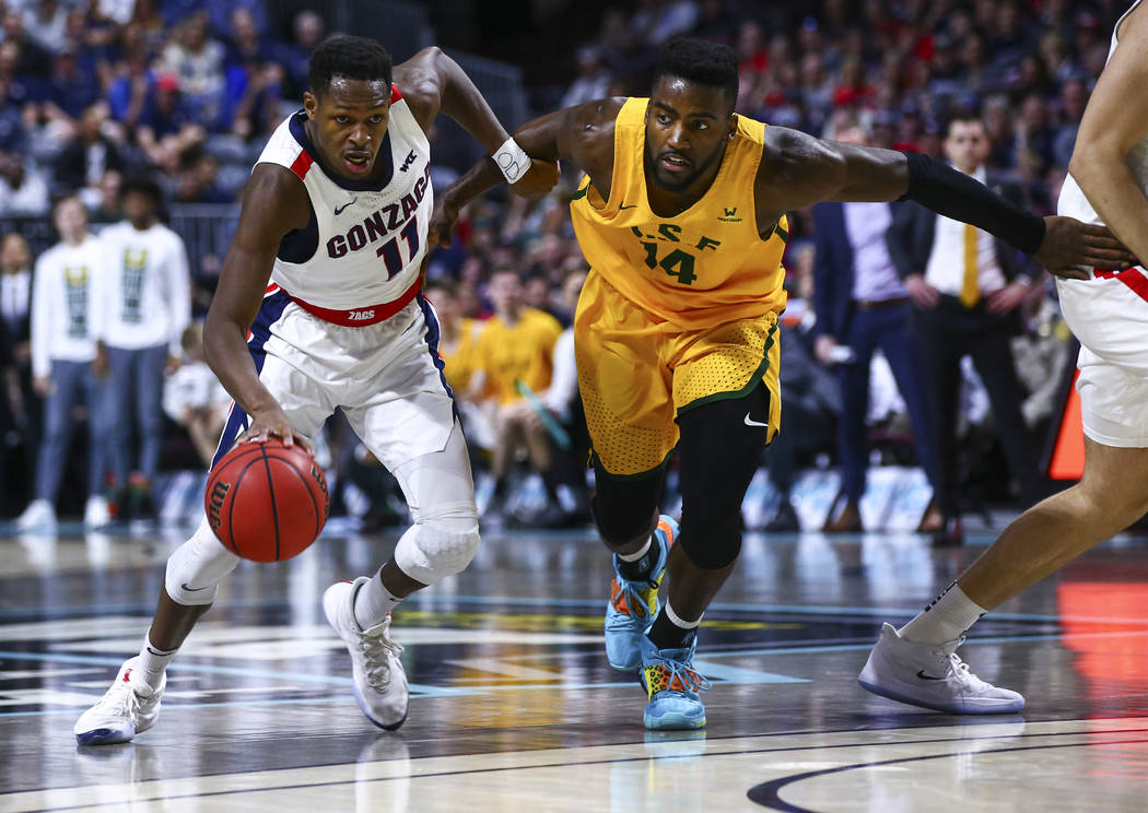 Gonzaga Bulldogs' Joel Ayayi (11) drives to the basket against San Francisco Dons' Charles Minl ...