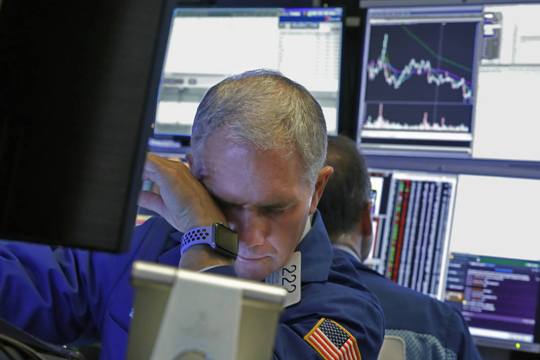 Specialist Timothy Nick works on the floor of the New York Stock Exchange, Monday, March 9, 202 ...