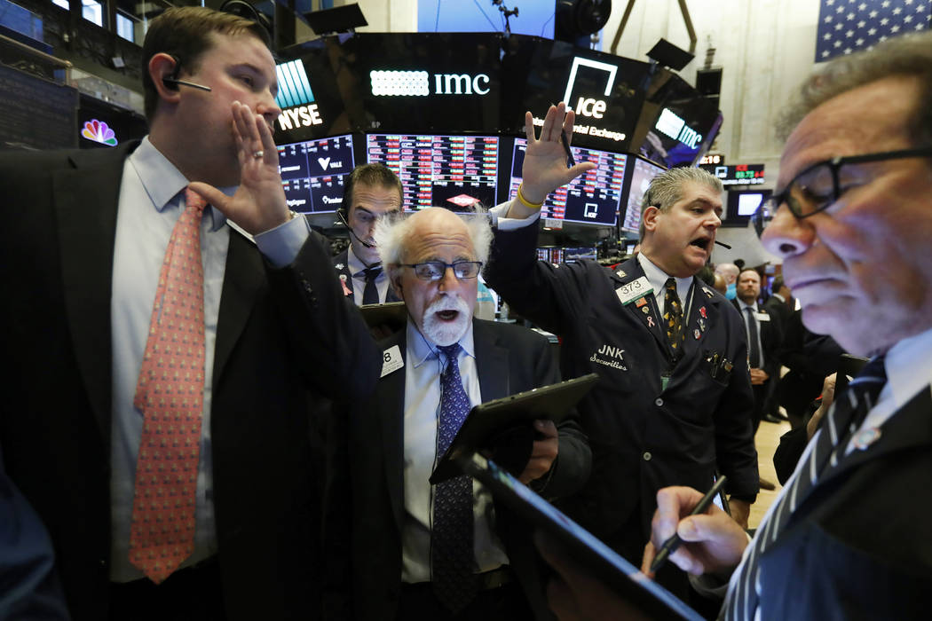 New York Stock Exchange Floor Governor Brendan Connolly, left, works with traders Peter Tuchman ...