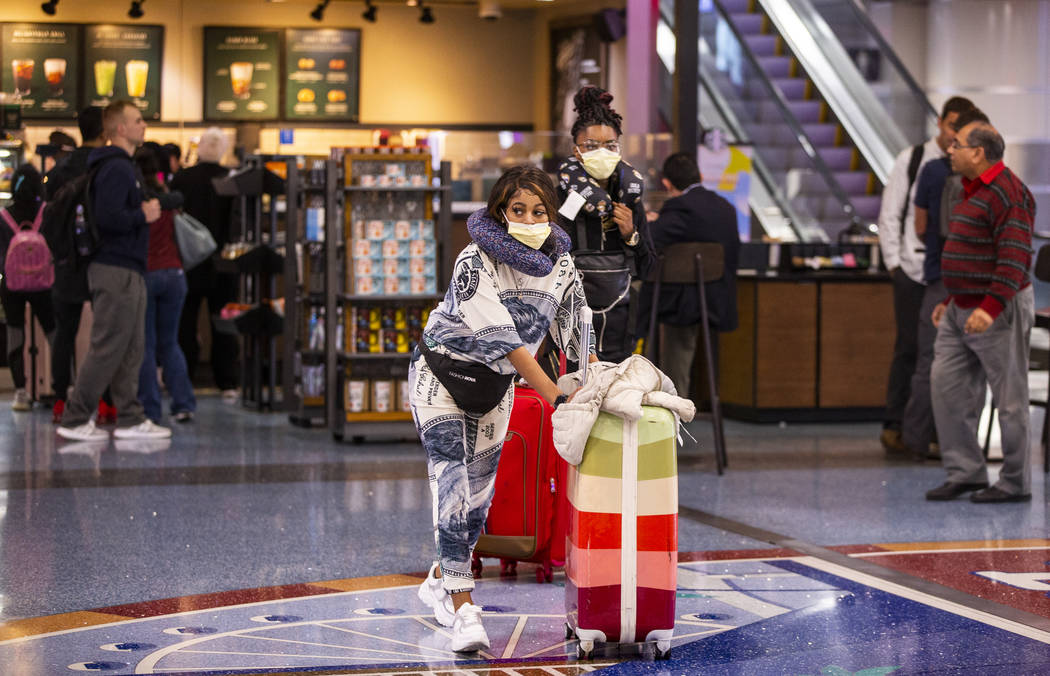 Passengers Keosha Grayson, left, and Britney Hubbard of Chattanooga, TN., wear face masks while ...