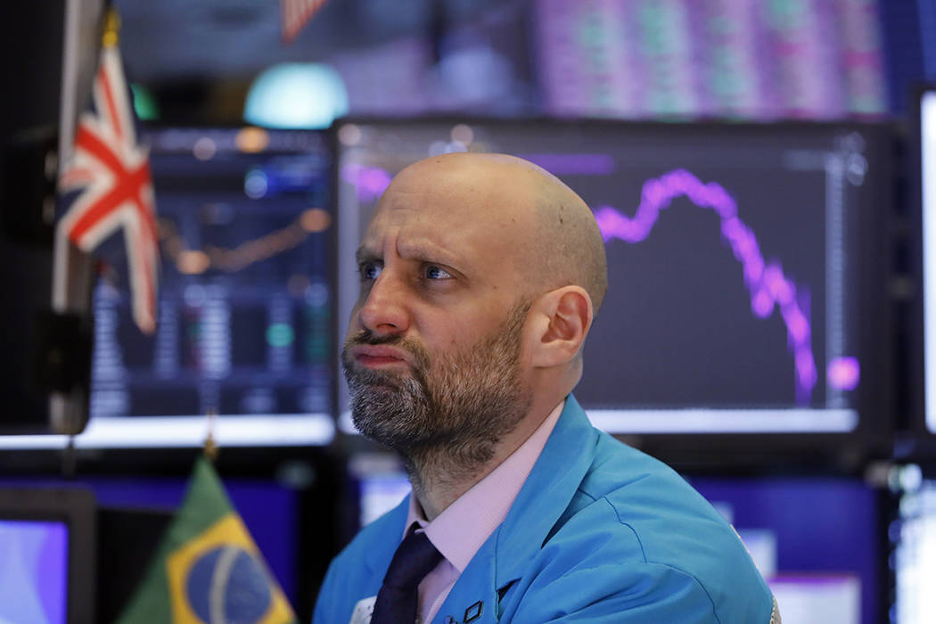 Specialist Meric Greenbaum works at his post on the floor of the New York Stock Exchange, Monda ...