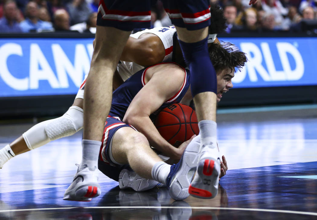 St. Mary's Gaels' Alex Ducas (44) tries to keep control of the ball against Gonzaga Bulldogs' A ...