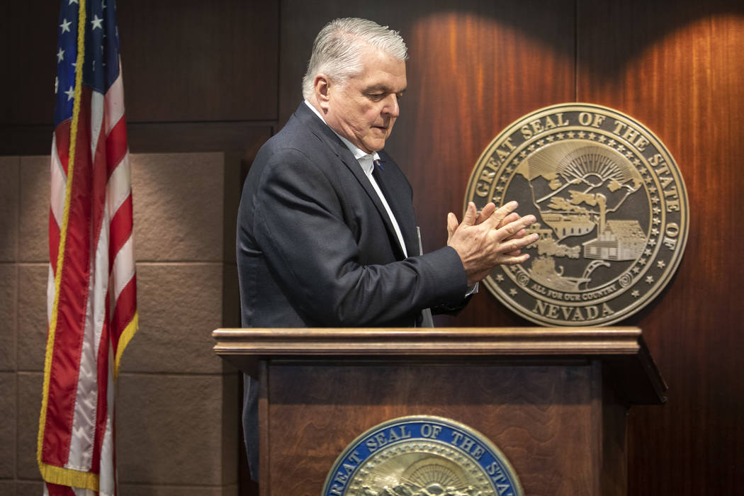 Gov. Steve Sisolak uses hand sanitizer before taking the podium to update the public about COVI ...