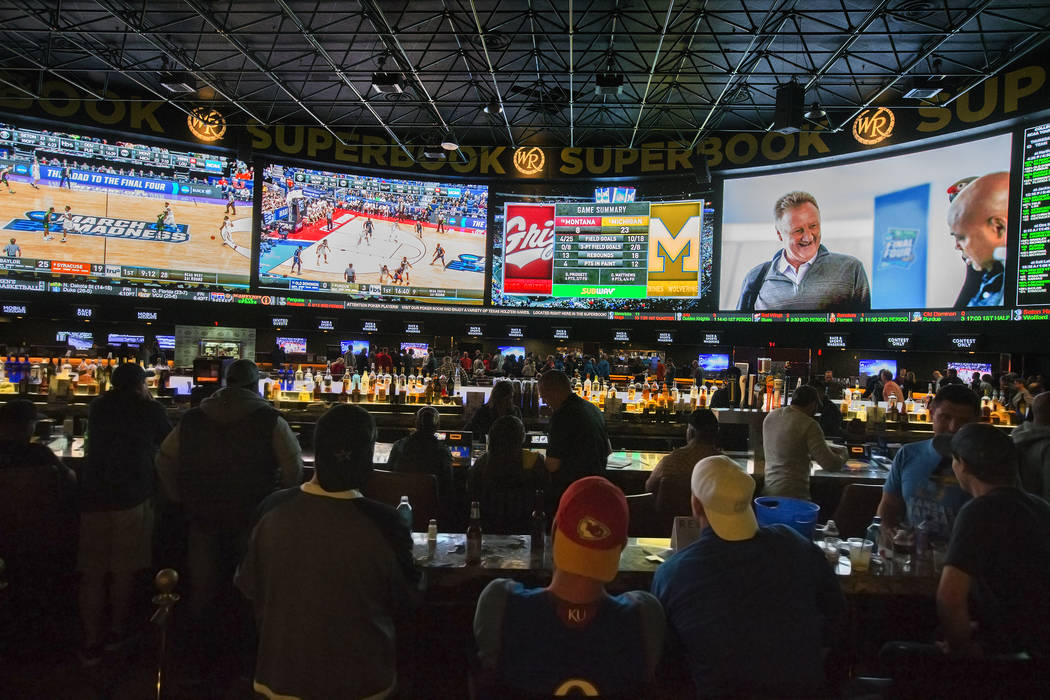 Basketball fans take in the first day of the NCAA Tournament at the Westgate Sportsbook on Marc ...