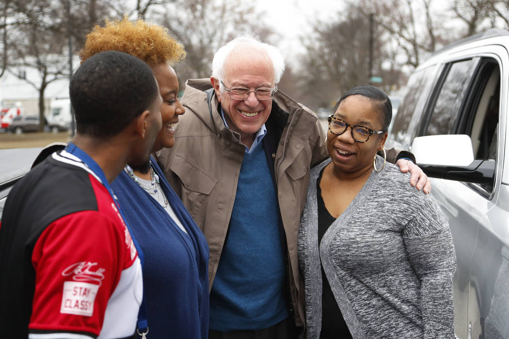 Democratic presidential candidate Sen. Bernie Sanders, I-Vt., visits custodian Davonta Bynes, f ...