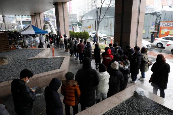In this March 10, 2020, photo, people queue in a line for the virus test outside of the Korea B ...