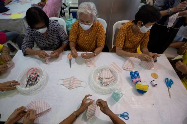 Volunteers assemble cloth masks for free at the Ministry of Social Development and Human Securi ...