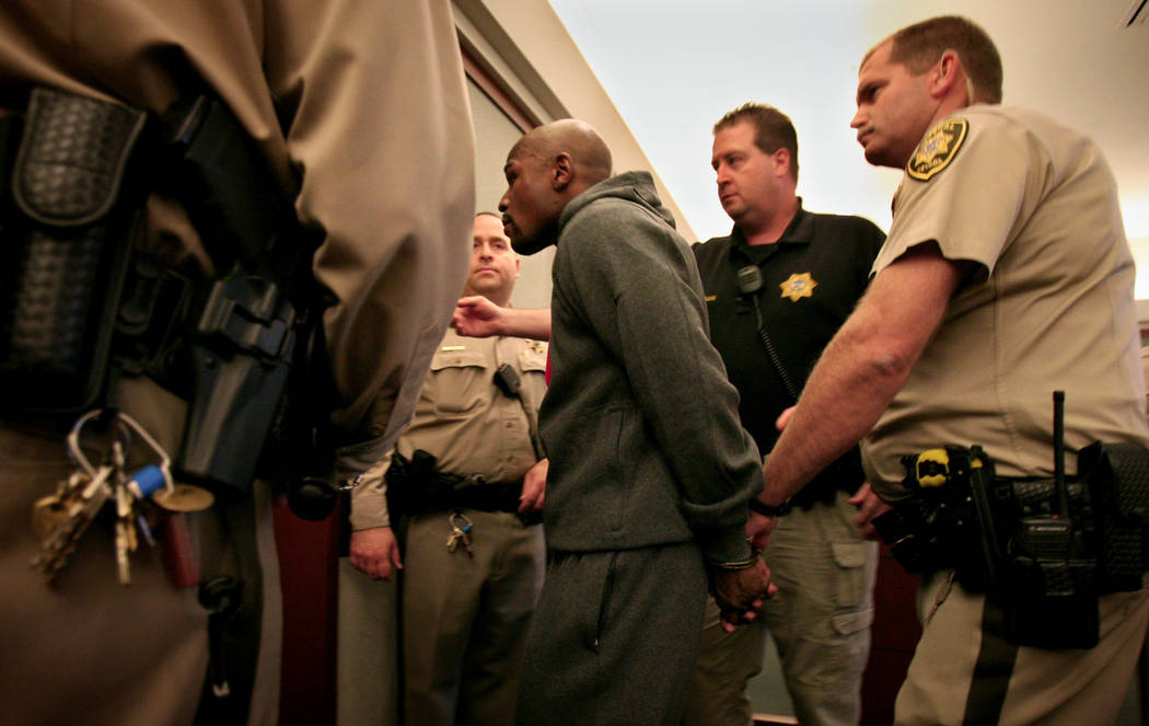 Officers escort boxer Floyd Mayweather Jr. out of Regional Justice Center courtroom Friday, Jun ...