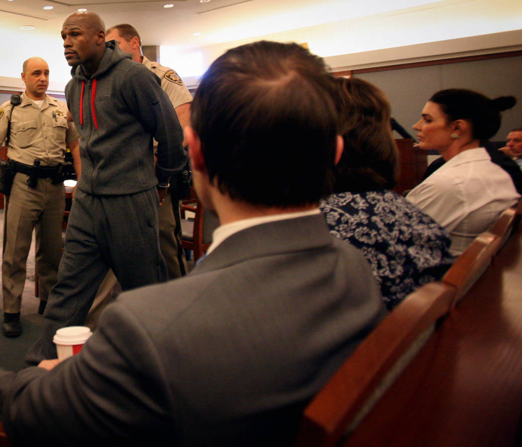 Officers escort boxer Floyd Mayweather Jr. out of courtroom at the Regional Justice Center Frid ...
