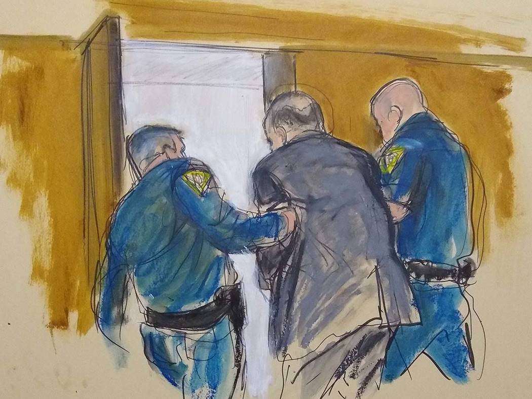 In this courtroom sketch, Harvey Weinstein, center, is led out of Manhattan Supreme Court by co ...