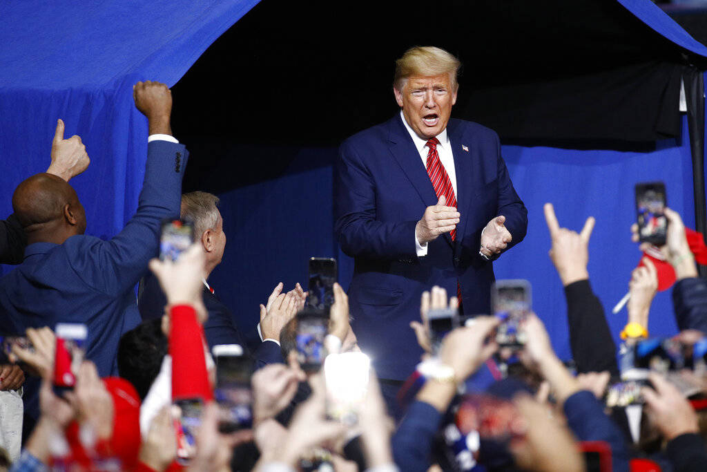 President Donald Trump walks onstage at a campaign rally, Friday, Feb. 28, 2020, in North Charl ...