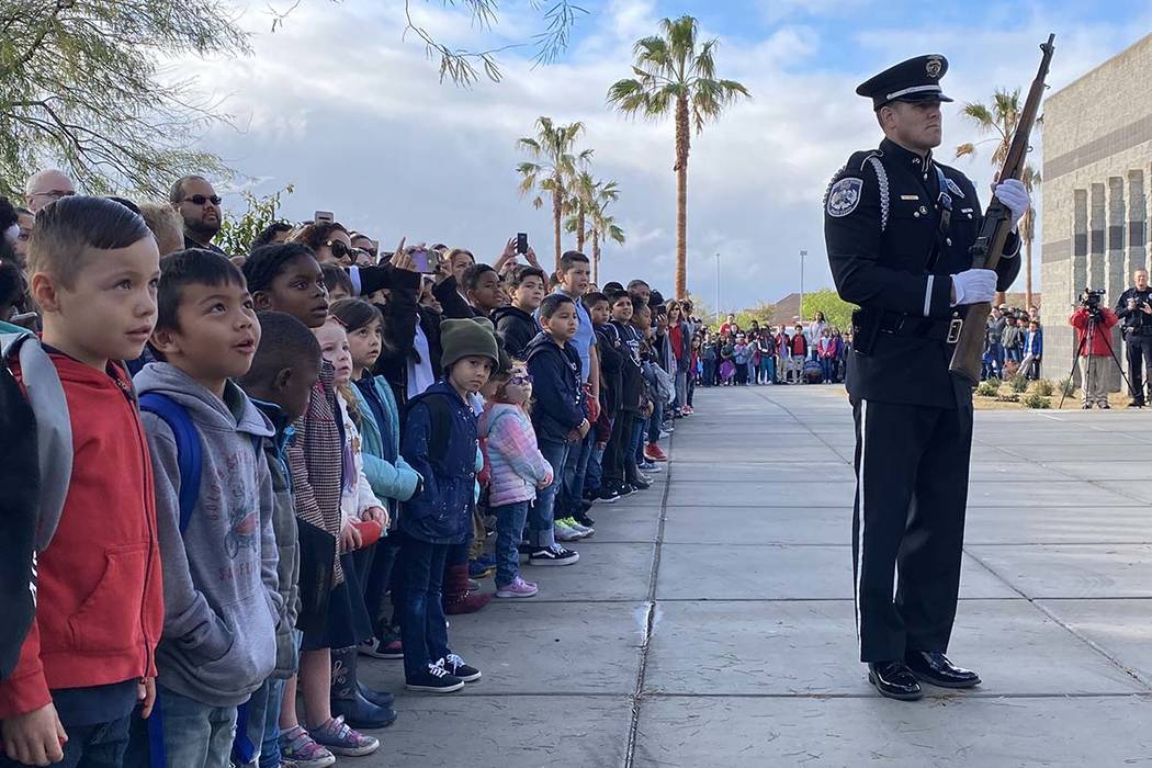 North Las Vegas Police Officer Guillermo Parra participates in honor guard ceremonies in front ...