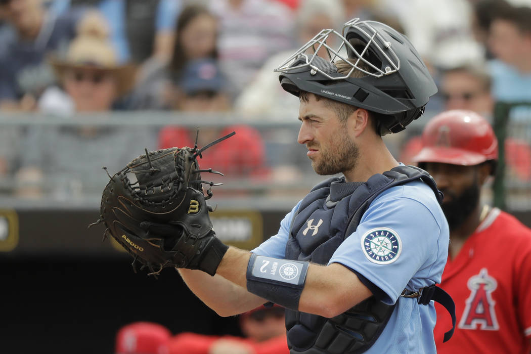 Seattle Mariners catcher Tom Murphy motions toward the field during a spring training baseball ...