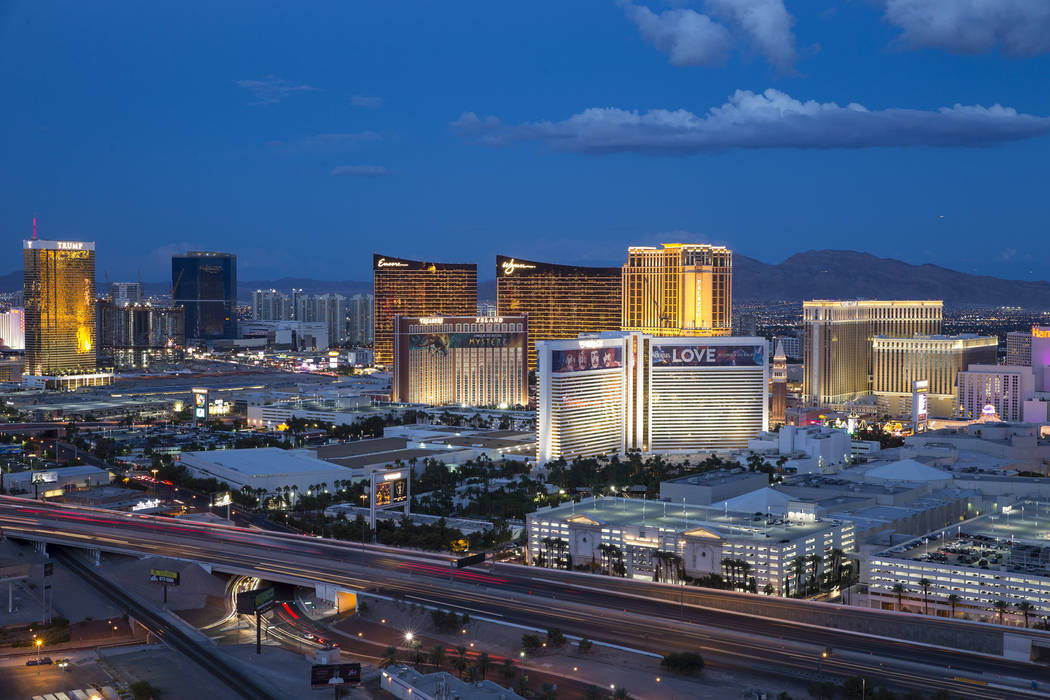 The Strip skyline lights up at dusk as seen from the VooDoo Lounge atop the Rio hotel-casino in ...