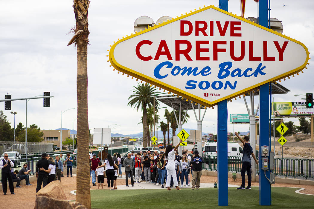 People line up to take photos by the "Welcome to Fabulous Las Vegas" sign in Las Vega ...