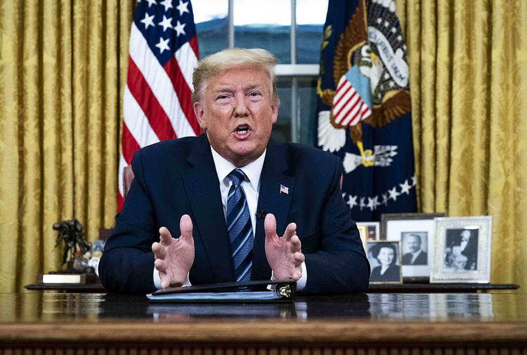 President Donald Trump speaks in an address to the nation from the Oval Office at the White Hou ...