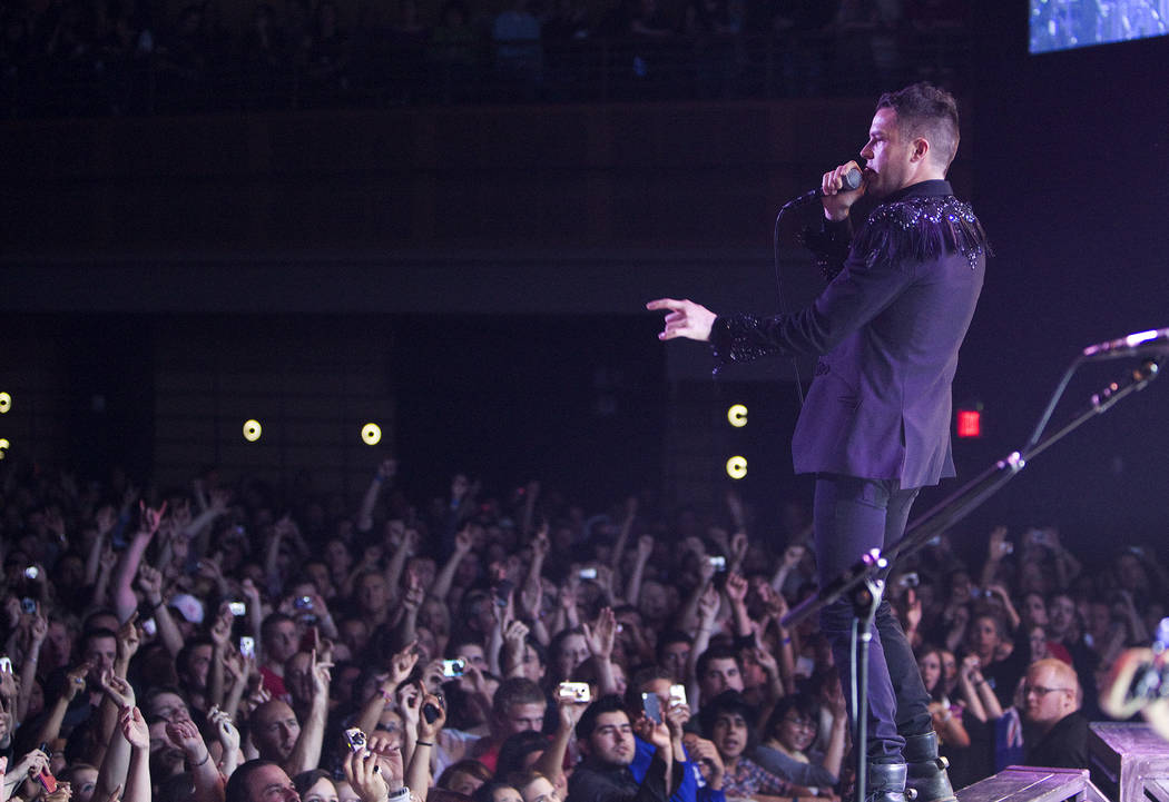 Brandon Flowers of The Killers performs with the band to a sold-out crowd during the opening ni ...