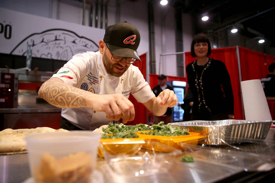 Federico De Silvestri of Verona, Italy, competes in the finals for the non-traditional pizza ca ...