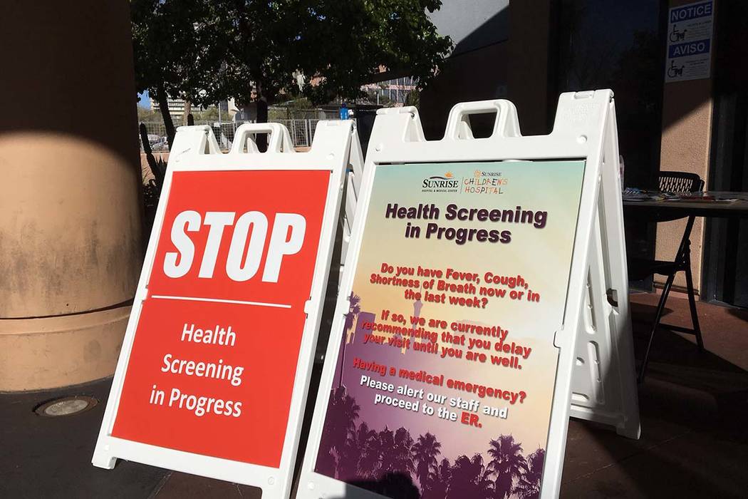 A sign outside the emergency room at Sunrise Hospital and Medical Center alerts patients about ...