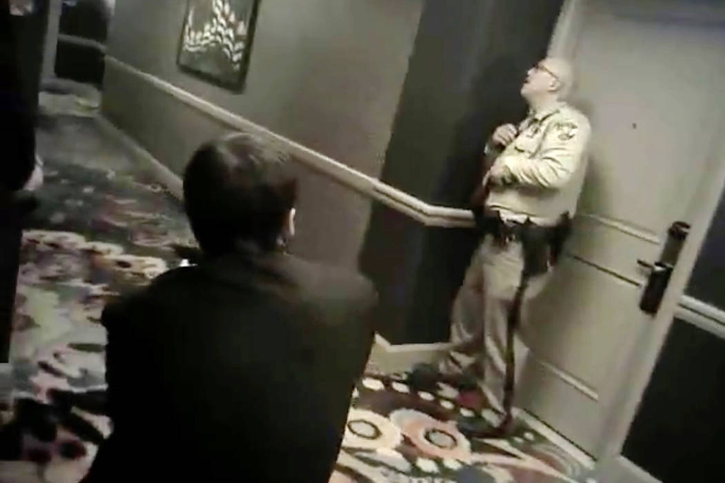 Newly released camera footage shows two Las Vegas police officers, paired with three armed Mand ...