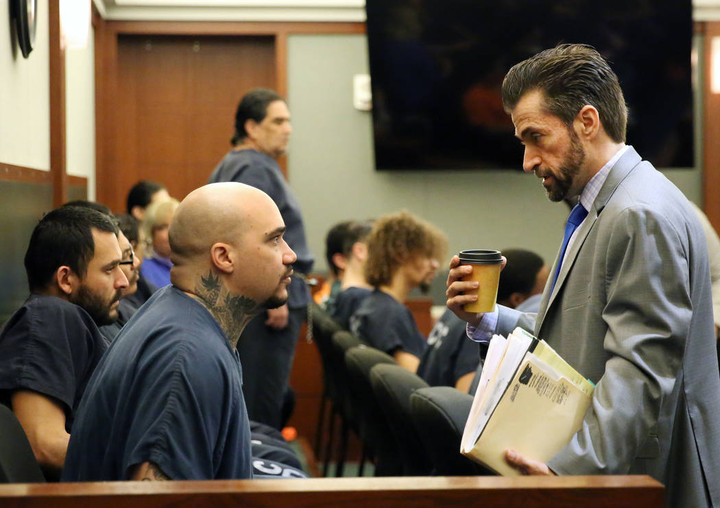 Christopher Weygant, left, talks to his attorney Abel Yanez before his sentencing at the Region ...