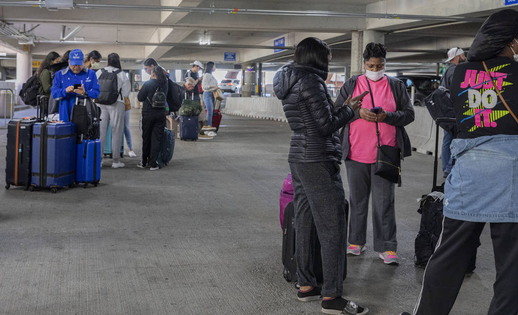 Passengers wait for the ride-hailing service at McCarran International Airport in Las Vega ...