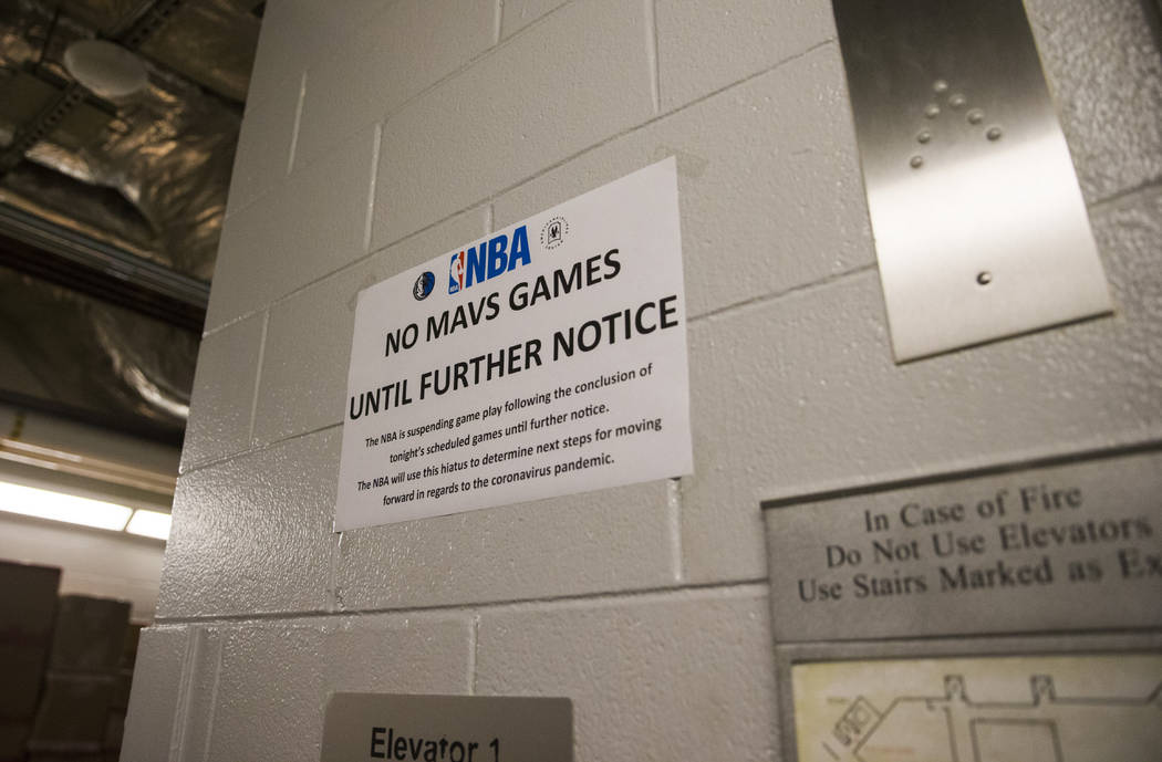 In this Wednesday, March 11, 2020 photo, a sign is posted at an elevator on the event level at ...