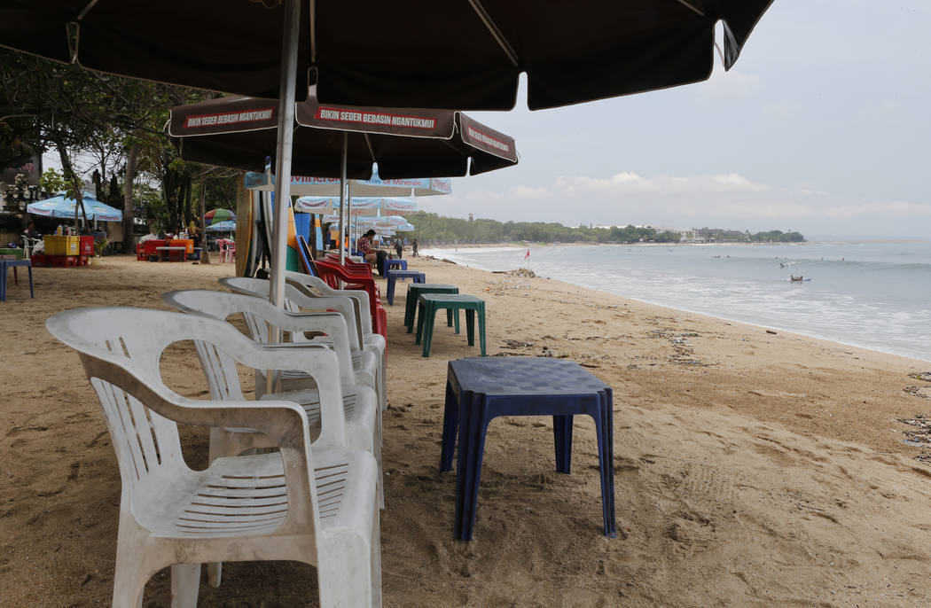 Empty chairs line Kuta Beach as tourism on the resort island has dropped due to the coronavirus ...