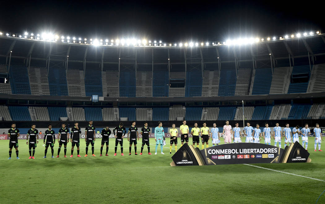 Players of Peru's Alianza Lima and Argentina's Racing Club line up before a Copa Libertadores s ...