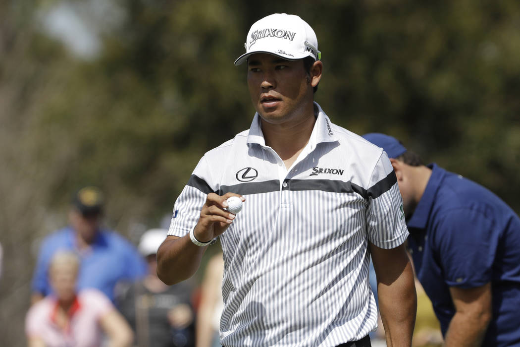Hideki Matsuyama of Japan, hold his ball after making a birdie putt on the seventh hole, during ...