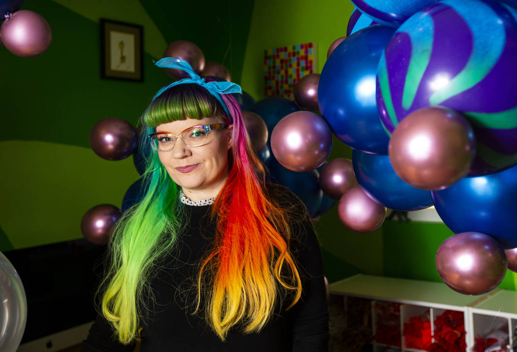 Balloon artist Tawney B. poses with her coronavirus balloons at her home in Las Vegas on Friday ...