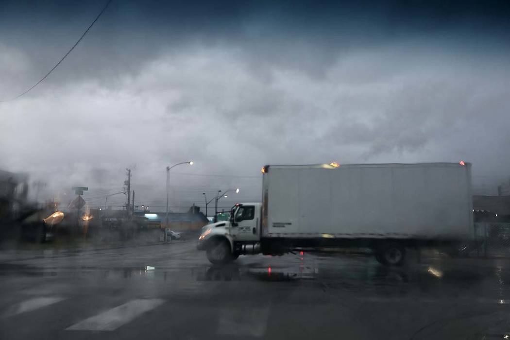 A truck drives through an intersection after heavy overnight rain in Las Vegas on Friday, March ...