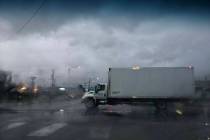 A truck drives through an intersection after heavy overnight rain in Las Vegas on Friday, March ...