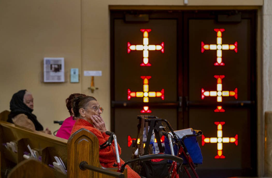 Elderly parishioners pray during Sunday Mass at St. Anne's Catholic Church where they were aske ...