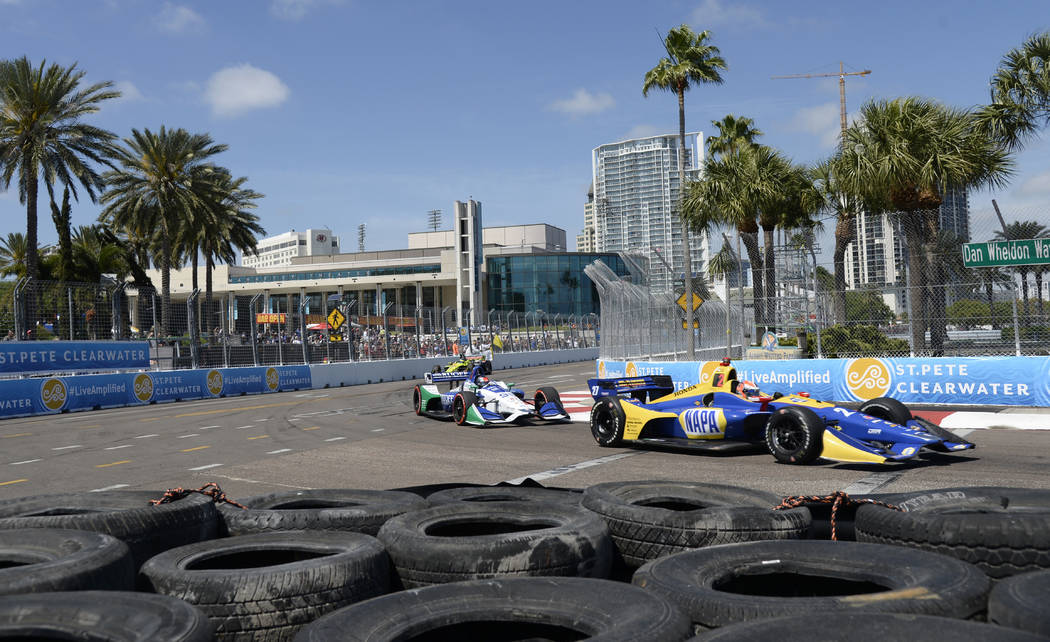 Alexander Rossi (27) and Marco Andretti (98) race through Turn 10 during the IndyCar Firestone ...
