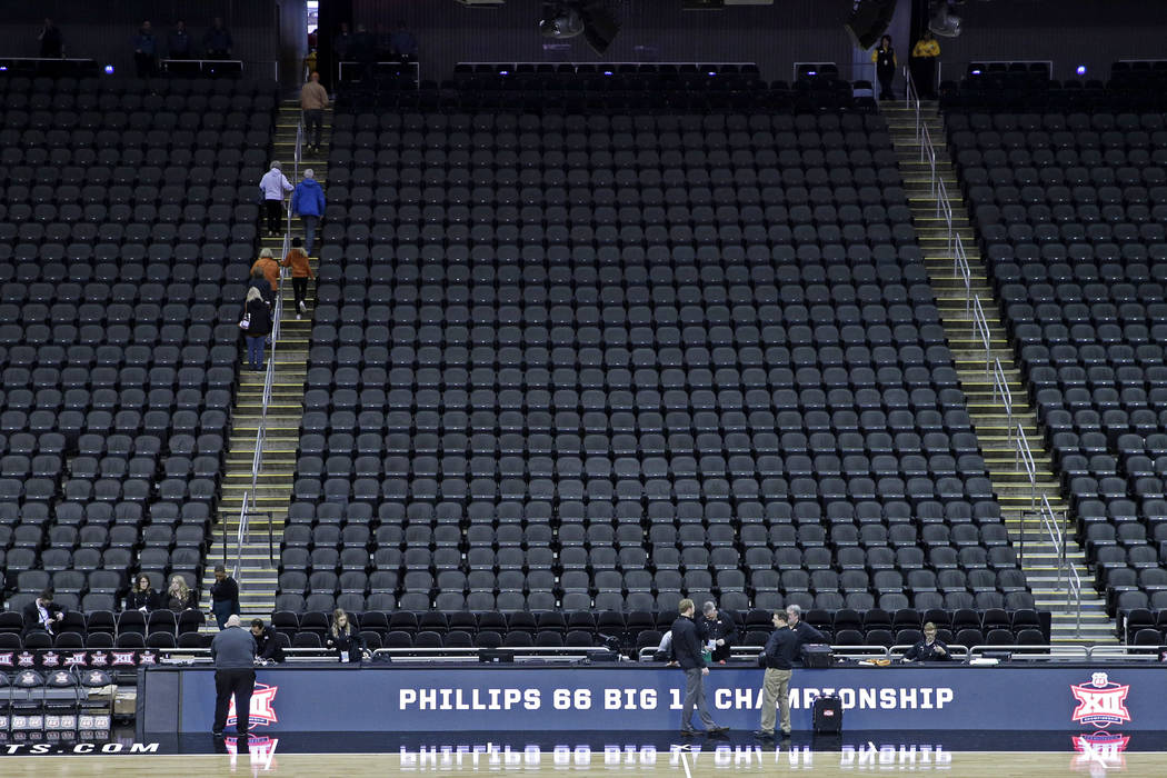 Fans leave the Sprint Center after the remaining NCAA college basketball games after in the Big ...