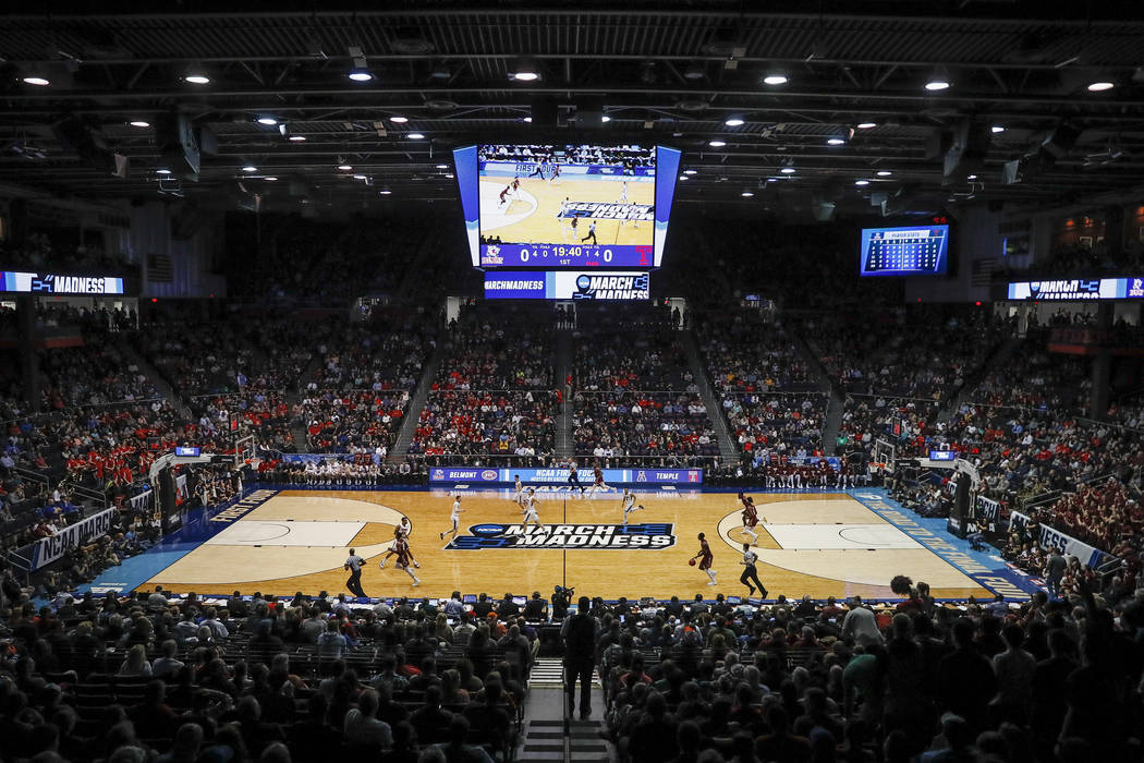 Spectators watch from the stands during the first half of a First Four game of the NCAA college ...