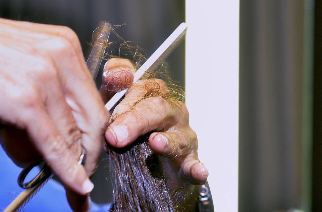 Cristophe Schatteman cuts Melinda Sheckells' hair at the Cristophe Salon in the MGM Grand hotel ...