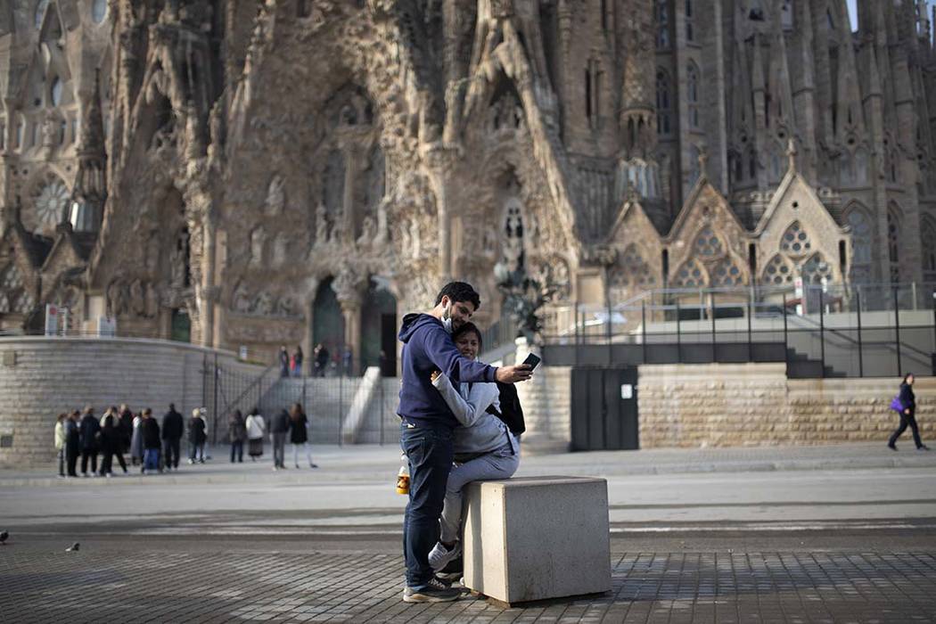 People take a selfie outside the Sagrada Familia basilica in Barcelona, Spain, Friday, March 13 ...