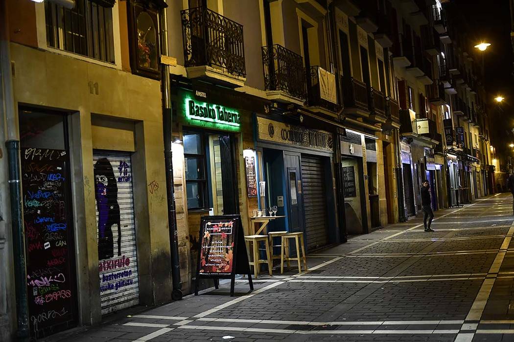 A person walks along the unusually deserted Saint Nicolas street, to prevent the spread of coro ...