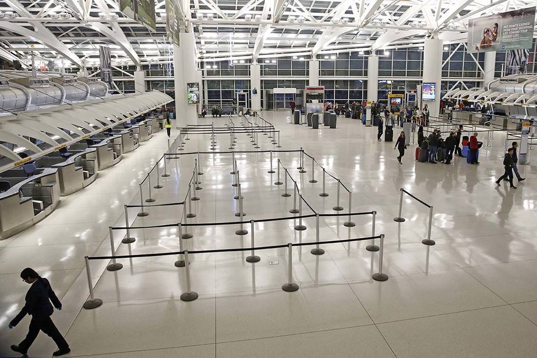 People visit an international terminal at John F. Kennedy airport, Friday, March 13, 2020, in N ...