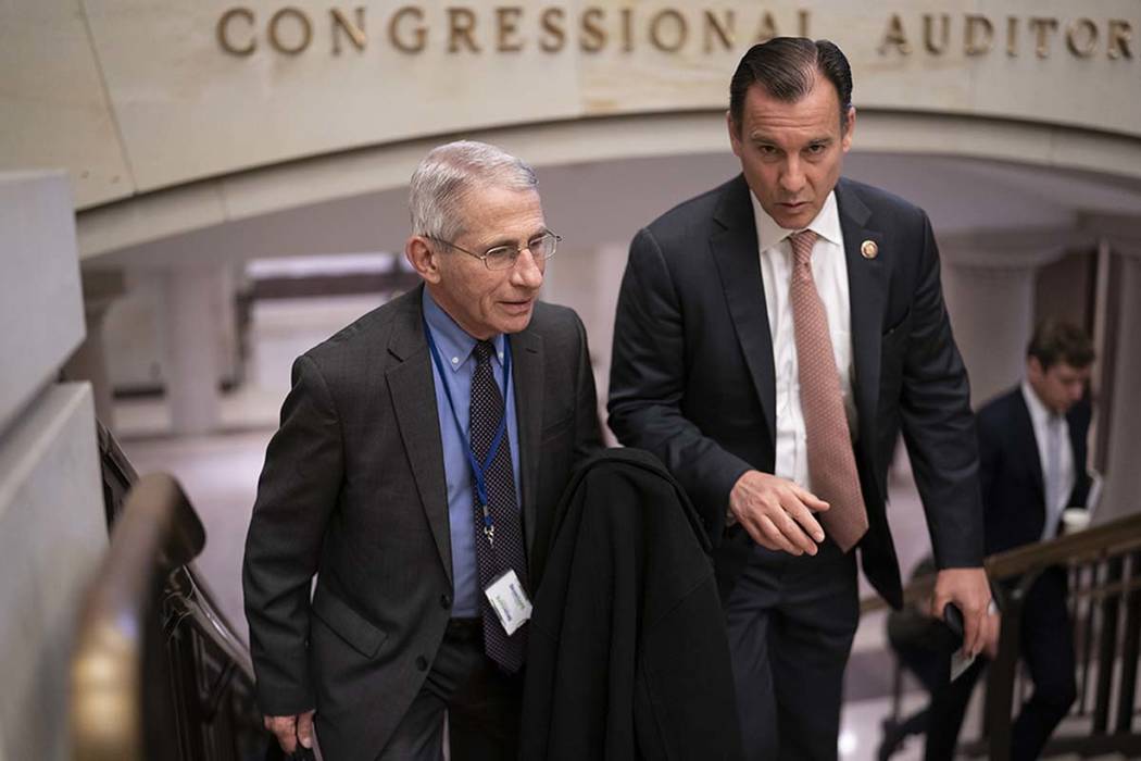 Dr. Anthony Fauci, left, director of the National Institute of Allergy and Infectious Diseases, ...