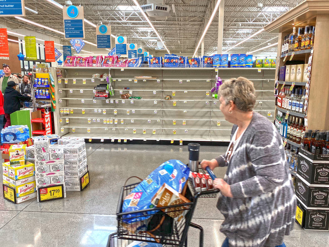 Shoppers faced many empty aisles while stocking up on essentials at Albertsons at 6730 N Hualap ...