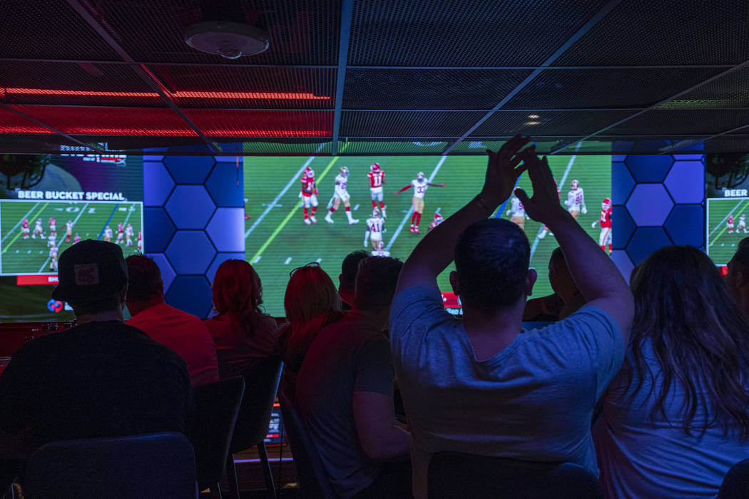 Individuals watch the NFL Super Bowl 54 football game between the San Francisco 49ers and Kansa ...