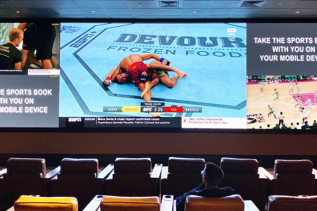 A single guest at the sports book at The Cromwell watches UFC on Saturday, March 14, 2020, in L ...