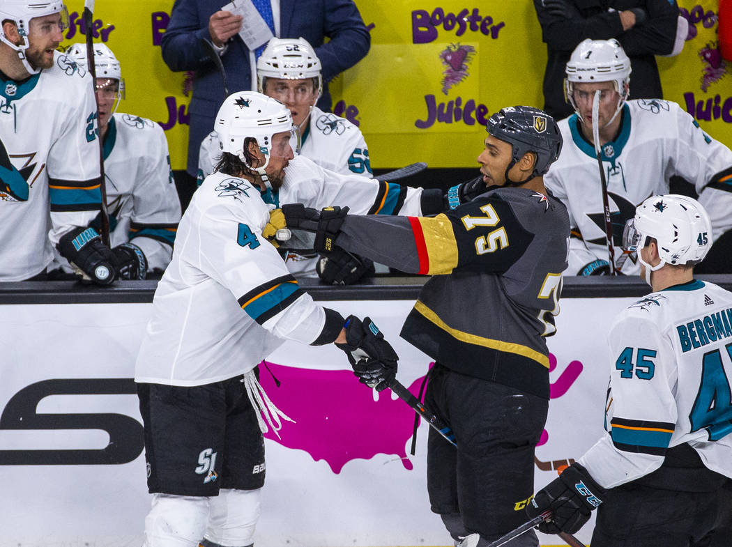 San Jose Sharks defenseman Brenden Dillon (4) grapples with Vegas Golden Knights right wing Rya ...