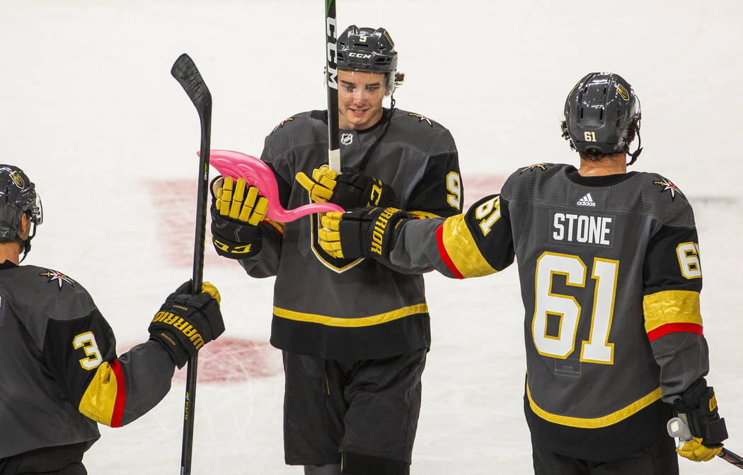 Vegas Golden Knights center Cody Glass (9) receives a pink flamingo from teammate right wing Ma ...